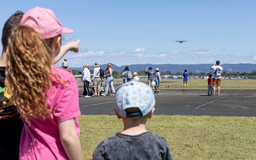 girl pointing at plane