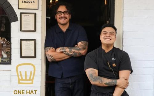 Cricca Chefs posing at door One hat on wall
